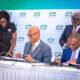 Ecobank Group CEO, Mr. Jeremy Awori (seated left) and AGF Group CEO, Mr. Jules Ngakam (seated right) append their signatures on the USD200 million risk-sharing agreement